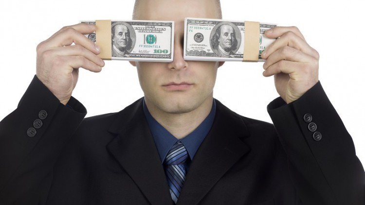 bald man covering eyes with banknote