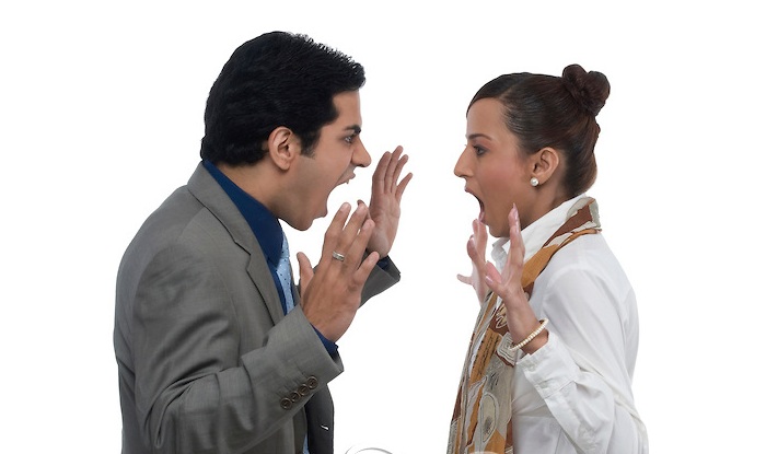 A young Indian man and woman arguing.