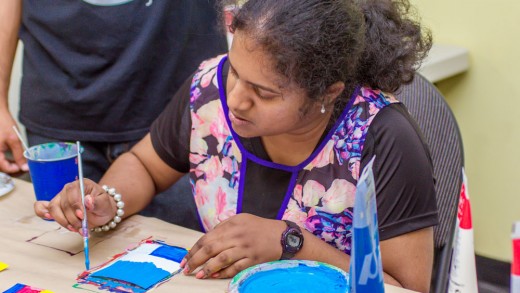 young girl with autism paints her card